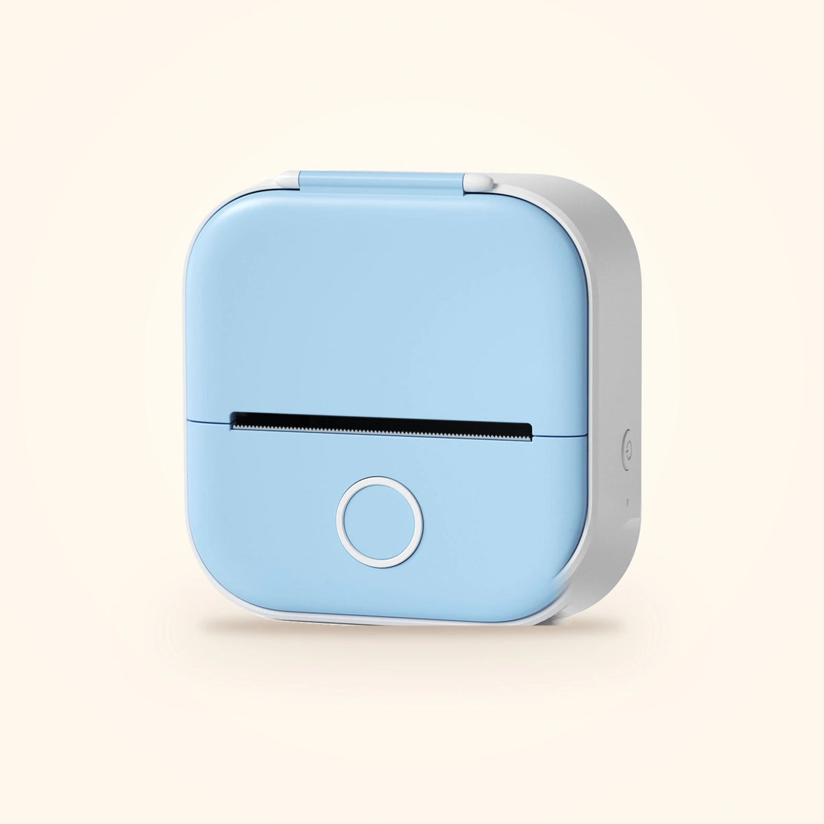 Mini imprimante à stickers du coffret Stickou, coloris bleu, posée sur fond crème